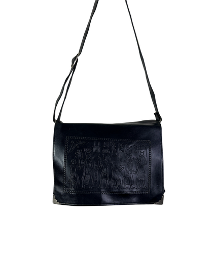 Black leather bag with embossed design on a white background