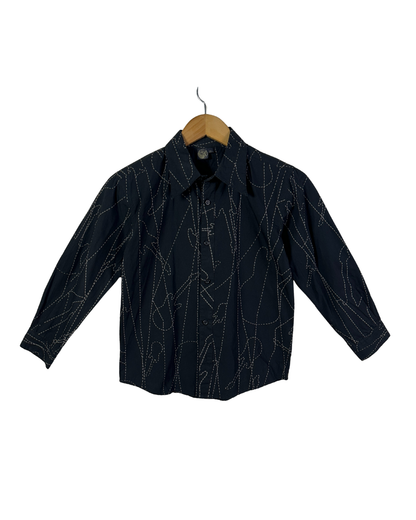 Black shirt with white patterns on a wooden hanger against a white background
