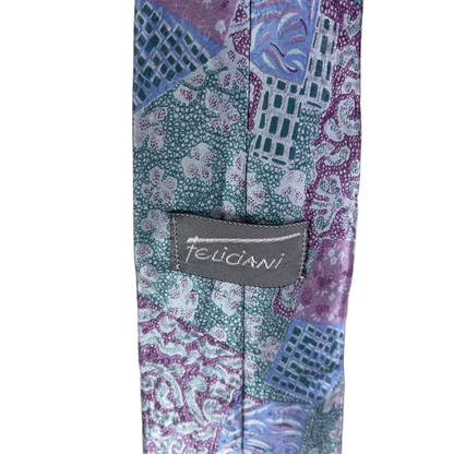 Patterned tie with a brand label on a neutral background