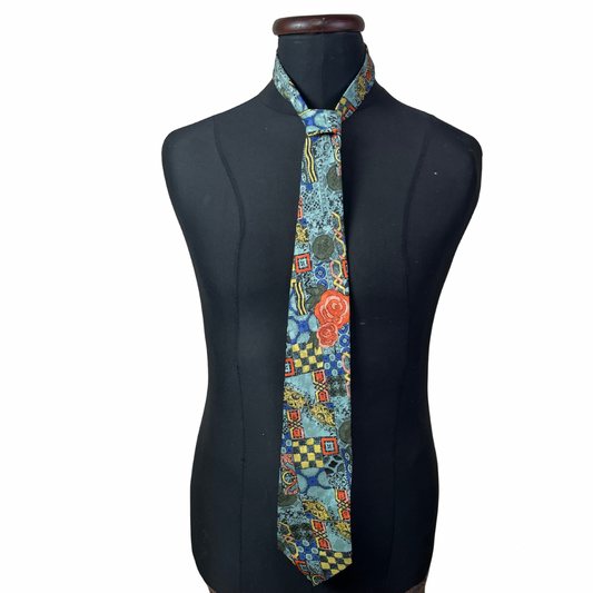 Colorful patterned tie on a black mannequin against a white background