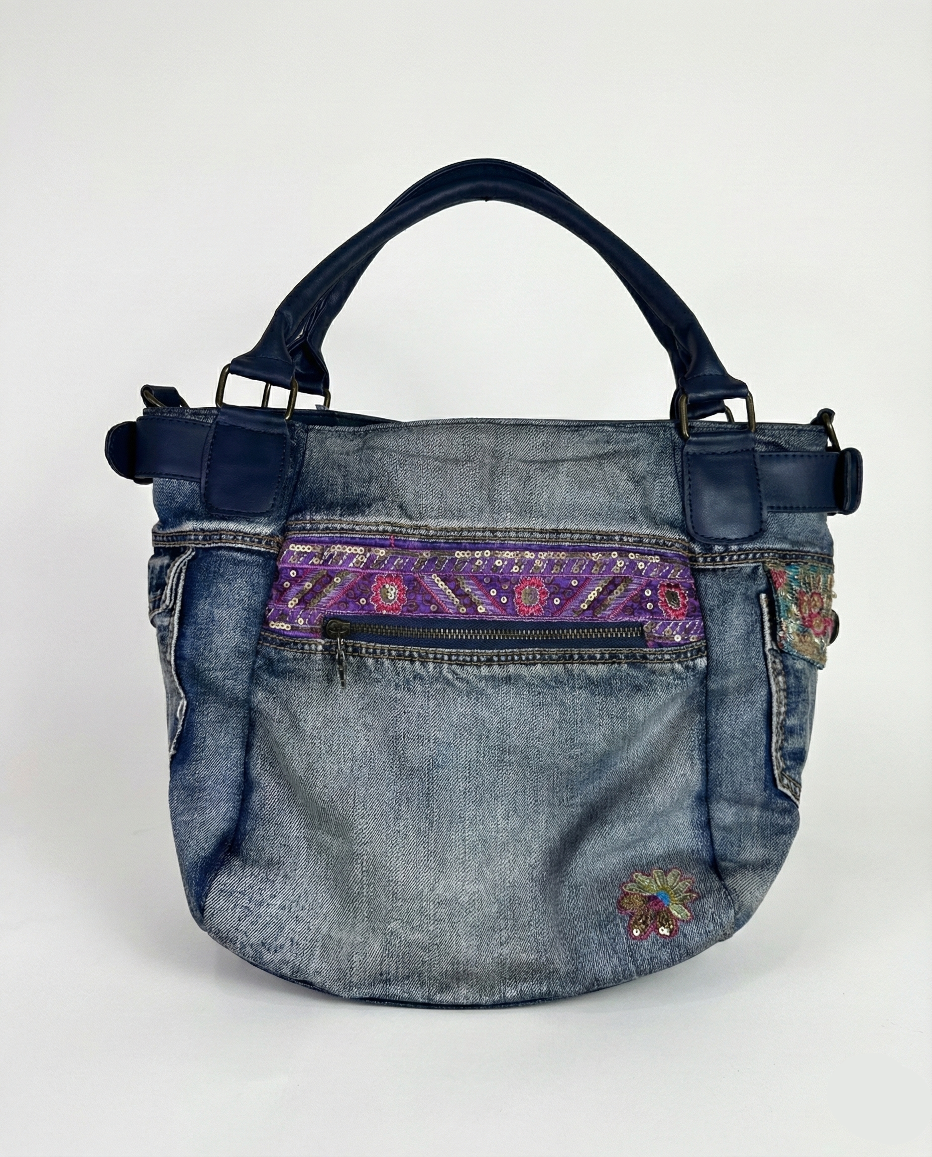 Denim handbag with purple and multicolor pattern on a white background