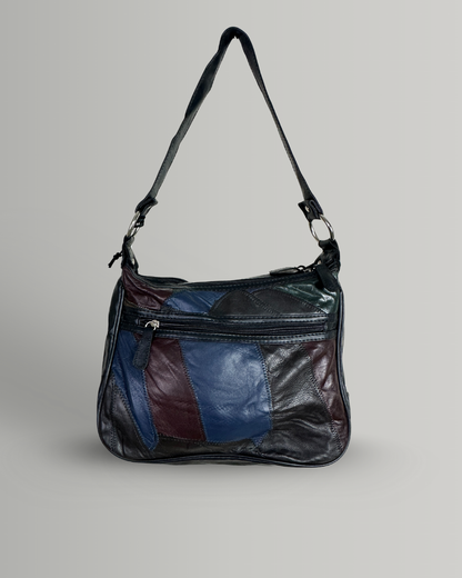 Multicolored leather handbag on a gray background