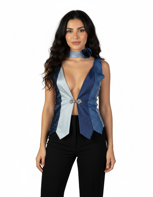 Woman wearing a blue and gray ruffled top with a white background