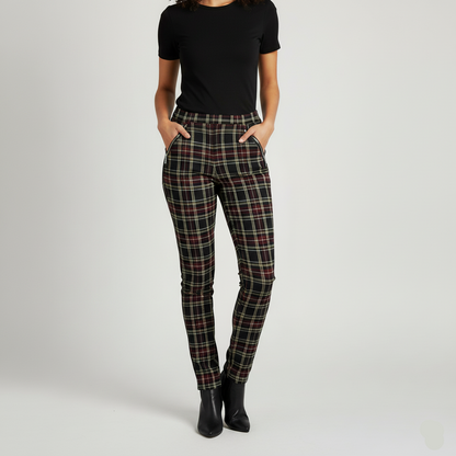 Person wearing plaid pants and a black top on a light gray background