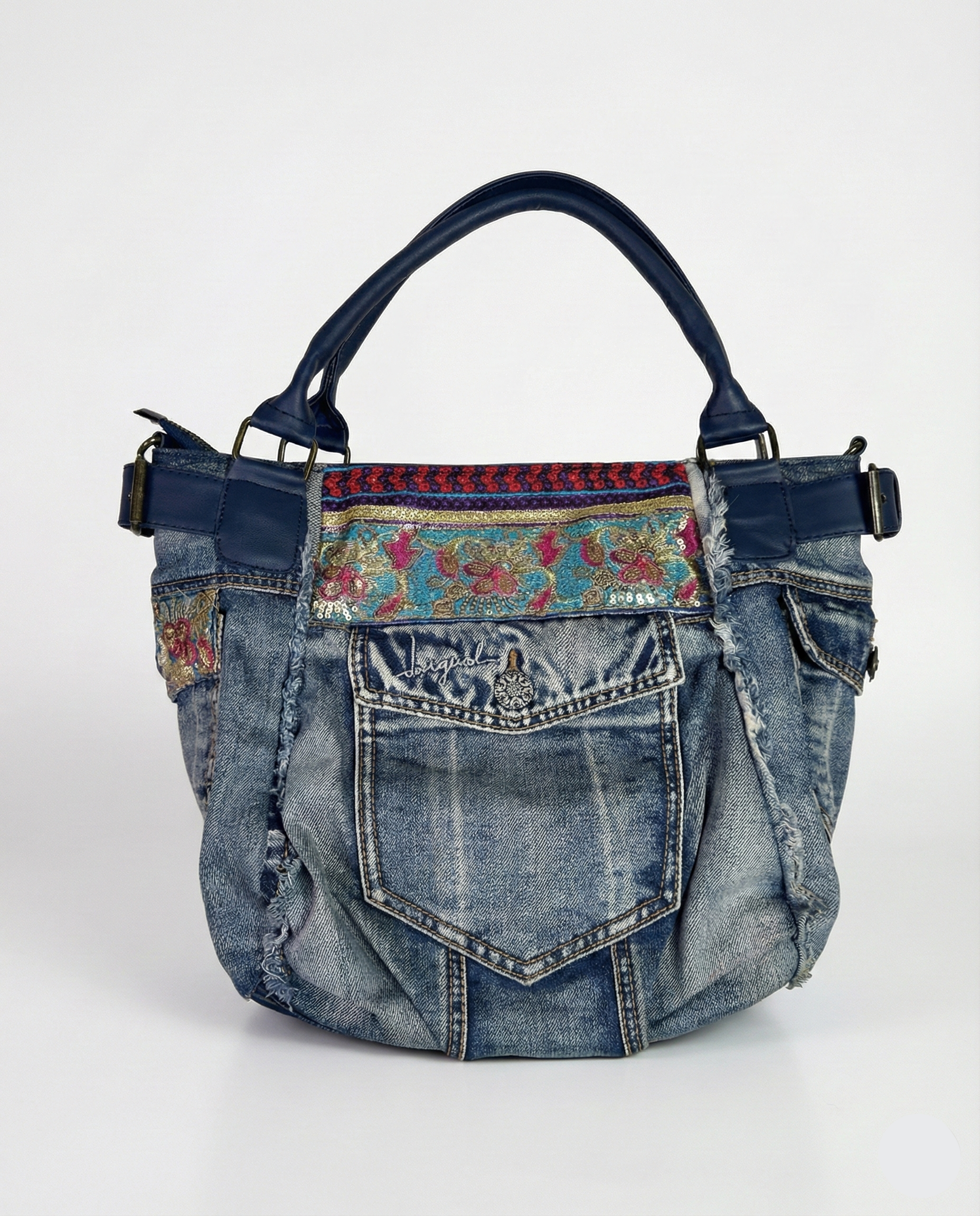 Denim handbag with floral patterned strap on a white background